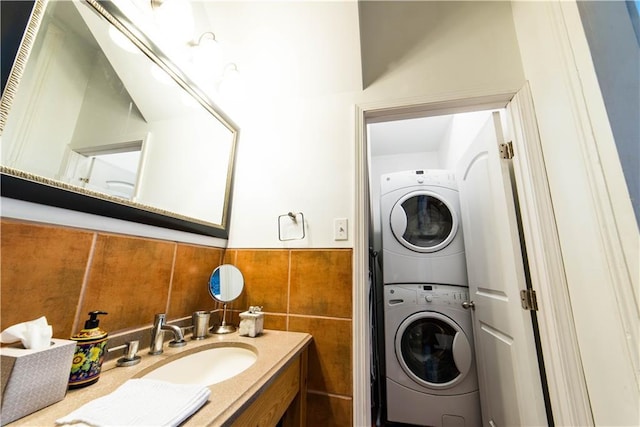 1418 Kerlerec St, New Orleans, LA 70116 - bathroom with vanity, stacked washer and clothes dryer, and tile walls