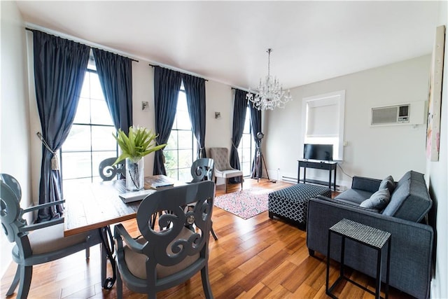 1418 Kerlerec St, New Orleans, LA 70116 - dining space featuring an inviting chandelier, an AC wall unit, and wood finished floors