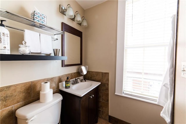 1418 Kerlerec St, New Orleans, LA 70116 - half bath featuring wainscoting, tile walls, vanity, and toilet