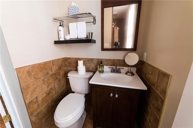 1418 Kerlerec St, New Orleans, LA 70116 - bathroom featuring vanity, wainscoting, toilet, and tile walls