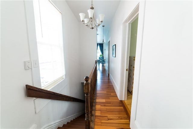 1418 Kerlerec St, New Orleans, LA 70116 - hall with light wood-style floors, baseboards, and a chandelier