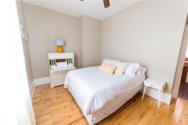 1418 Kerlerec St, New Orleans, LA 70116 - bedroom with baseboards, ceiling fan, and light wood-style floors