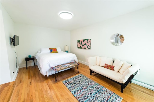 1418 Kerlerec St, New Orleans, LA 70116 - bedroom featuring baseboards, a baseboard heating unit, and wood finished floors
