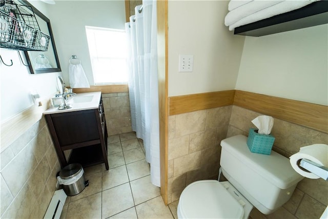 1418 Kerlerec St, New Orleans, LA 70116 - full bath featuring wainscoting, baseboard heating, vanity, toilet, and tile walls