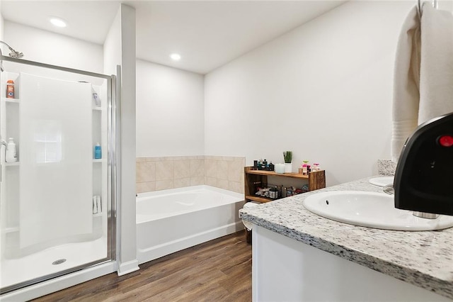 23162 Rosa Blvd, Robert, LA 70455 - bathroom featuring a bath, wood finished floors, a shower stall, and recessed lighting
