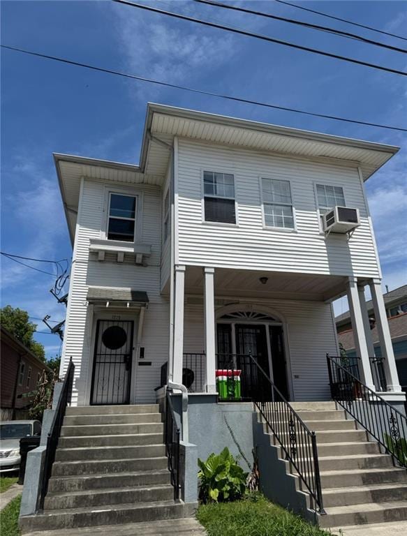 view of front of house featuring stairs and covered porch