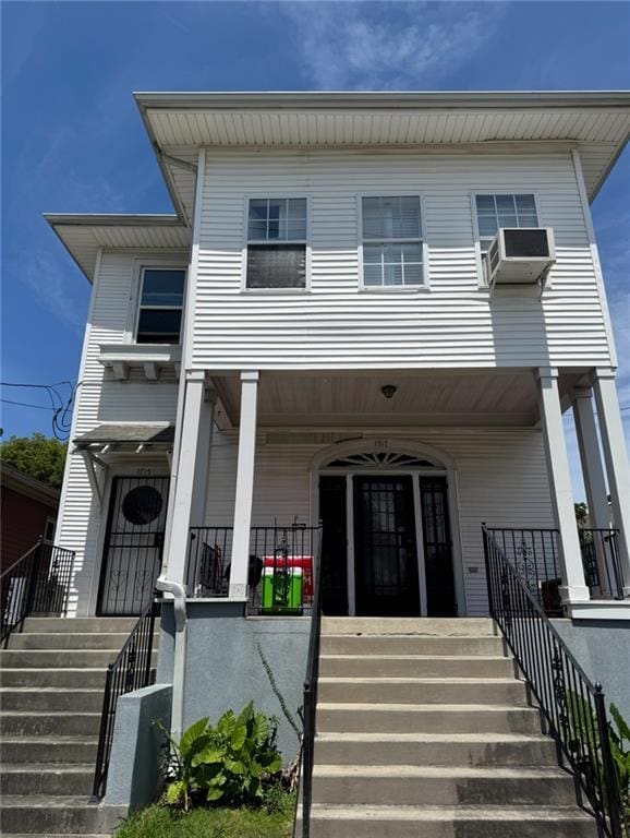 view of front of property featuring stairs and a porch