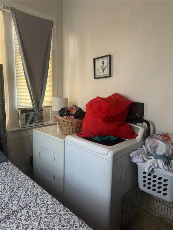 laundry room with laundry area, cooling unit, and washing machine and clothes dryer