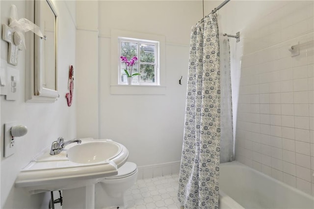 full bathroom with shower / tub combo and toilet