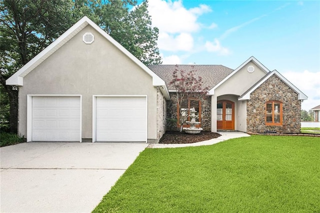 14300 S Lakeshore Dr, Covington, LA 70435 - view of front of house featuring stone siding, concrete driveway, a front lawn, stucco siding, and a garage