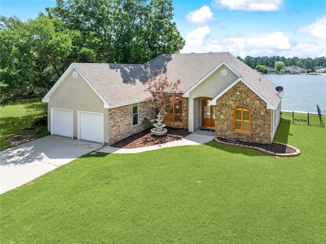 14300 S Lakeshore Dr, Covington, LA 70435 - single story home featuring stone siding, a garage, concrete driveway, and a water view