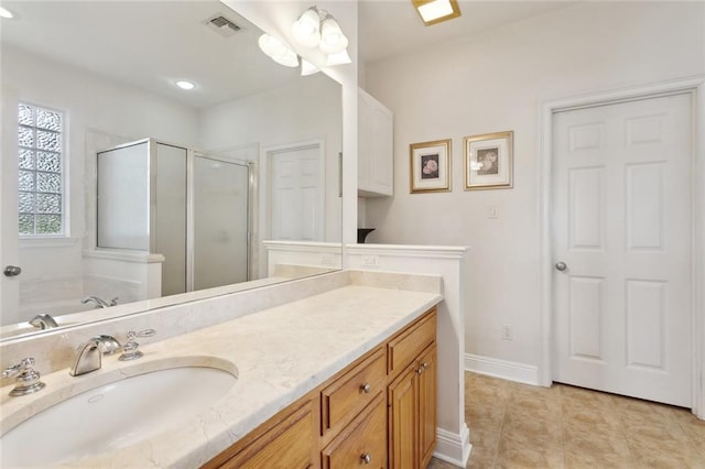 14300 S Lakeshore Dr, Covington, LA 70435 - full bathroom featuring a shower stall, vanity, baseboards, a bath, and tile patterned flooring