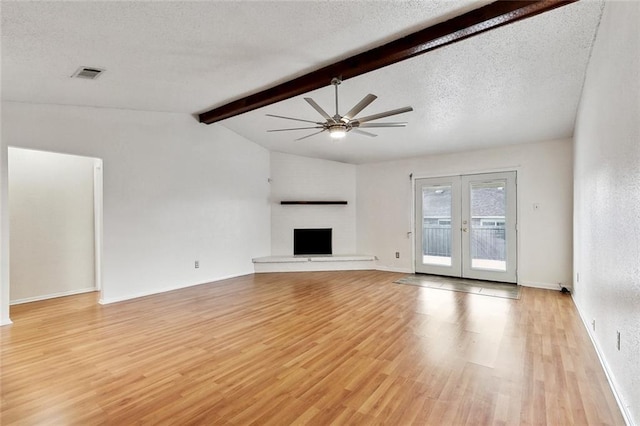 unfurnished living room featuring visible vents, lofted ceiling with beams, light wood-type flooring, french doors, and a ceiling fan