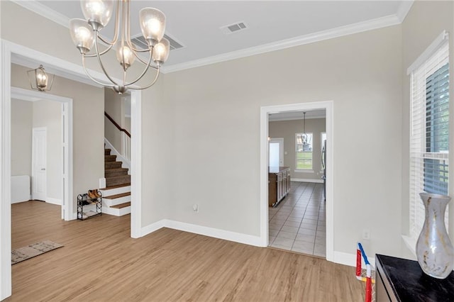 interior space featuring light wood-style floors, a notable chandelier, stairs, and visible vents