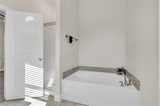 bathroom featuring tile patterned flooring and a bath