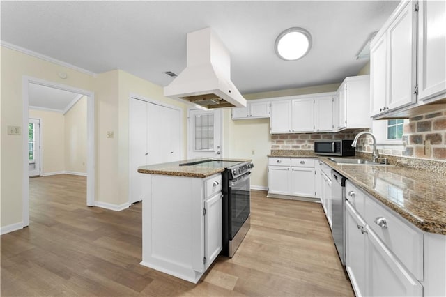 kitchen featuring island range hood, a sink, white cabinets, light wood-style floors, and stainless steel appliances