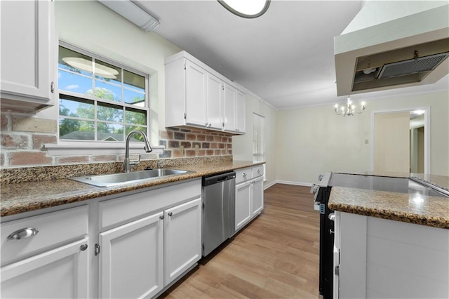 kitchen with appliances with stainless steel finishes, light wood-type flooring, white cabinetry, a sink, and extractor fan
