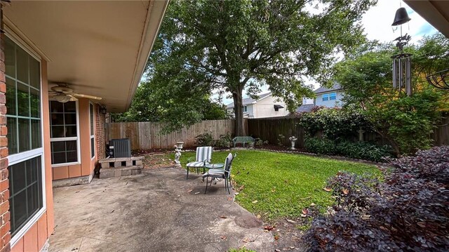 view of yard with a fenced backyard, central air condition unit, ceiling fan, and a patio area