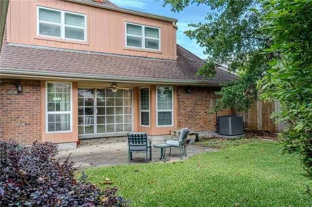 back of property featuring roof with shingles, fence, a patio area, central air condition unit, and a yard