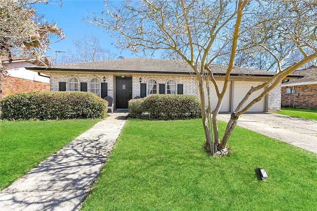 single story home featuring brick siding, an attached garage, driveway, and a front lawn