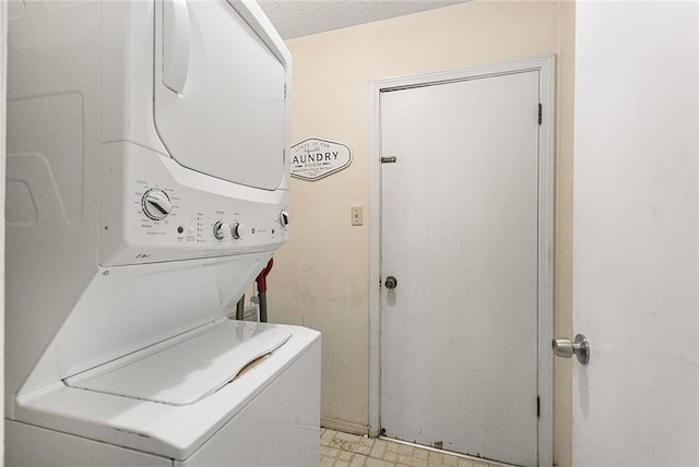laundry area with light floors, stacked washer and clothes dryer, and laundry area