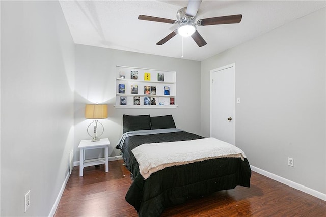 bedroom featuring a ceiling fan, baseboards, and dark wood-type flooring