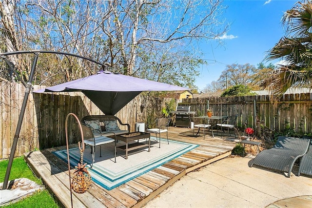 view of patio / terrace with a fenced backyard, area for grilling, and a deck