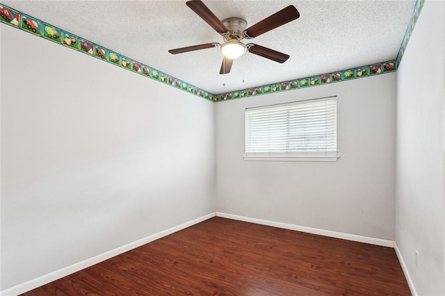 spare room with baseboards, a ceiling fan, a textured ceiling, and wood finished floors