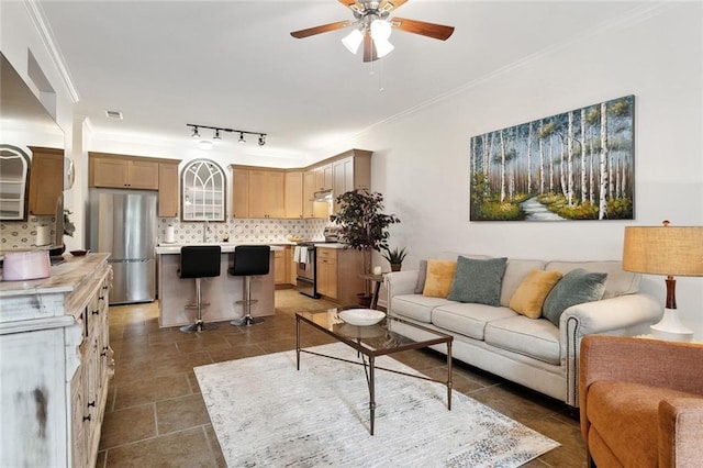 living room featuring crown molding, a ceiling fan, and visible vents
