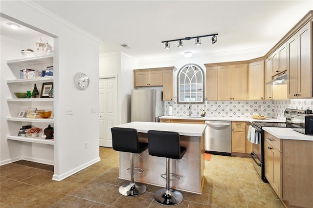 kitchen featuring stainless steel appliances, backsplash, a kitchen bar, under cabinet range hood, and a kitchen island
