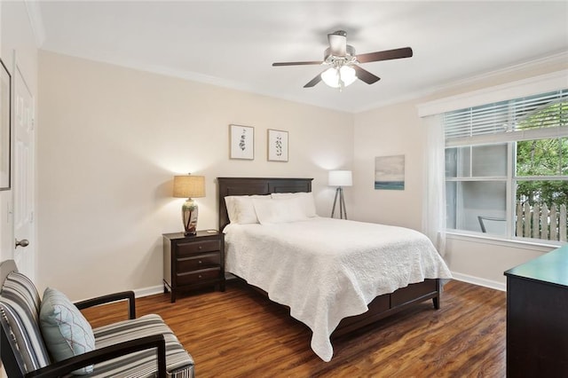 bedroom featuring crown molding, a ceiling fan, dark wood-style flooring, and baseboards