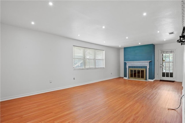 3205 Lake Trail Dr, Metairie, LA 70003 - unfurnished living room featuring recessed lighting, a fireplace with flush hearth, light wood-style floors, and visible vents