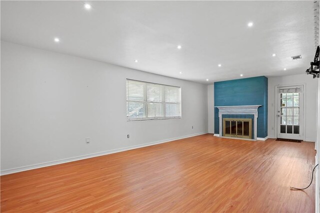 3205 Lake Trail Dr, Metairie, LA 70003 - unfurnished living room with recessed lighting, light wood-type flooring, and a fireplace with flush hearth