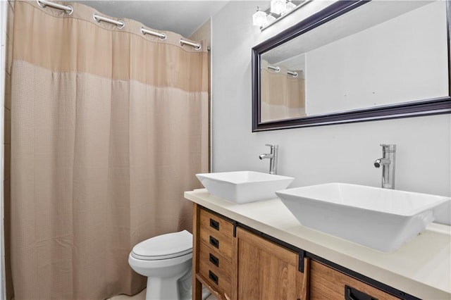 3205 Lake Trail Dr, Metairie, LA 70003 - bathroom featuring double vanity, a sink, curtained shower, and toilet