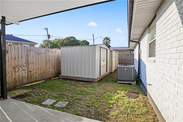 3205 Lake Trail Dr, Metairie, LA 70003 - view of yard with an outbuilding, central AC unit, a shed, and a fenced backyard
