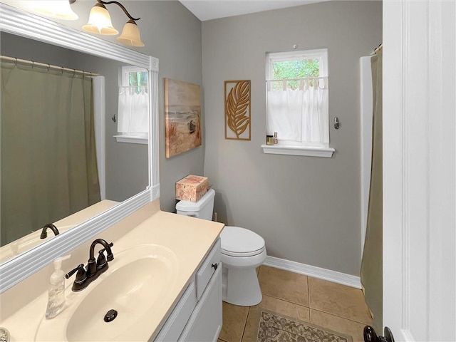 full bathroom featuring vanity, tile patterned flooring, baseboards, and toilet