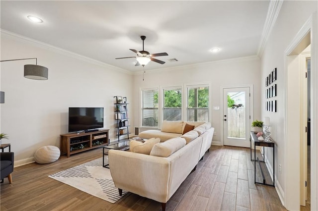 living area featuring baseboards, ceiling fan, crown molding, and wood finished floors
