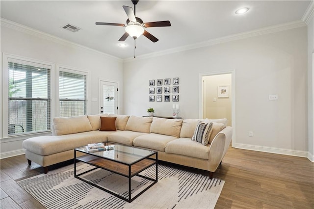 living area with baseboards, plenty of natural light, and visible vents