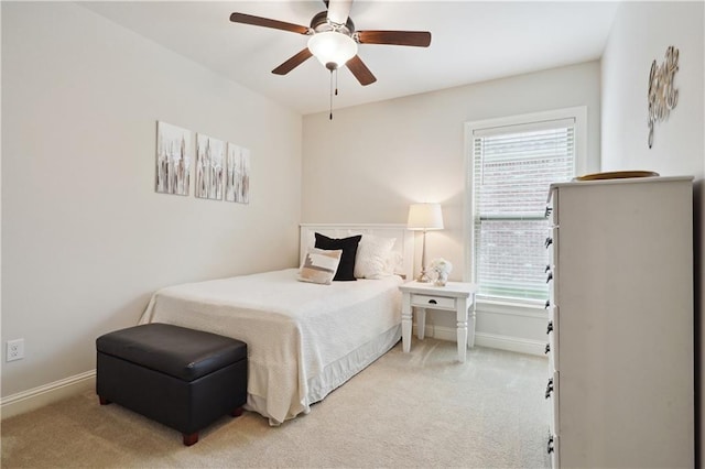 carpeted bedroom with baseboards, ceiling fan, and multiple windows