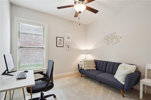 office space featuring baseboards, a ceiling fan, and carpet