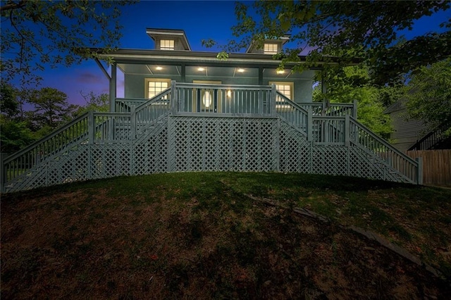 back of house with a yard and stairway