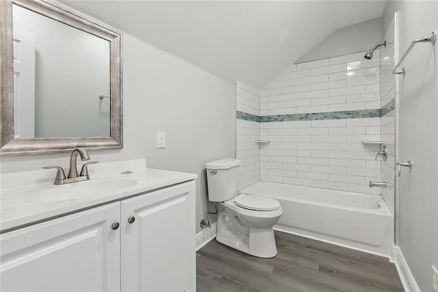 2951 Camellia Dr, Slidell, LA 70458 - bathroom with toilet, wood finished floors,  shower combination, vaulted ceiling, and vanity