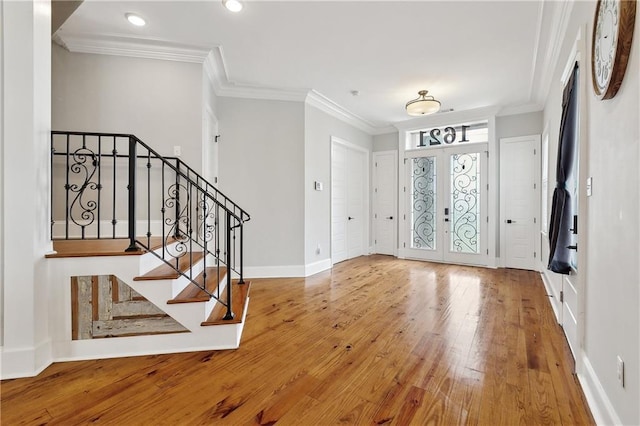 foyer with baseboards, ornamental molding, recessed lighting, and hardwood / wood-style floors
