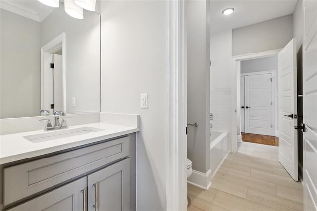 bathroom with vanity, toilet, recessed lighting, tub / shower combination, and ornamental molding