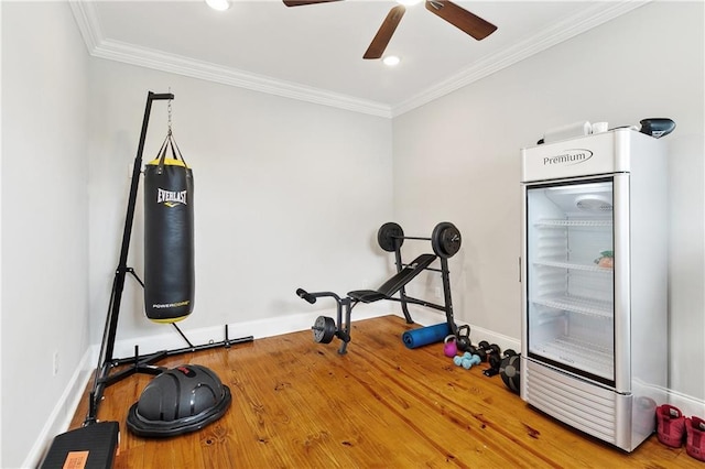 workout area with crown molding, baseboards, and ceiling fan