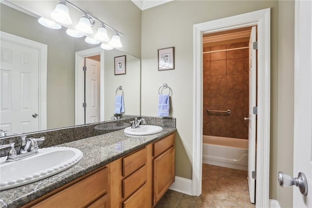 bathroom with tile patterned flooring, a sink, baseboards, and double vanity