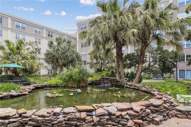 surrounding community featuring a garden pond