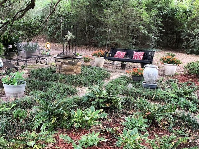 view of yard with a fire pit
