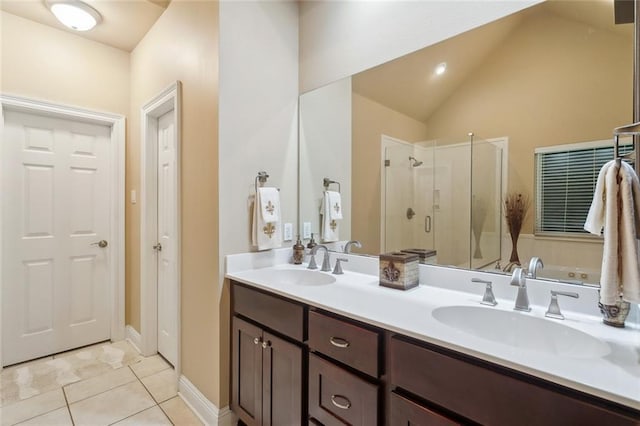 bathroom with a sink, tile patterned floors, a shower stall, and double vanity