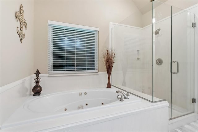 bathroom with a tub with jets, vaulted ceiling, and a shower stall